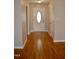 Welcoming entryway featuring a decorative front door and pristine hardwood floors at 411 Joneshaven Dr, Fuquay Varina, NC 27526