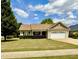 Inviting one-story home featuring a well-manicured lawn and a charming front porch at 411 Joneshaven Dr, Fuquay Varina, NC 27526