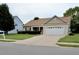 Charming single-story home with an attached garage and a spacious driveway at 411 Joneshaven Dr, Fuquay Varina, NC 27526