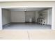 Spacious garage with ample storage shelves and a utility sink, providing practical space for vehicles and projects at 411 Joneshaven Dr, Fuquay Varina, NC 27526