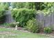 Landscaped yard featuring a decorative bird bath surrounded by a variety of plants and flowers at 411 Joneshaven Dr, Fuquay Varina, NC 27526