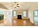 Bright living room featuring a cozy fireplace and hardwood flooring throughout at 411 Joneshaven Dr, Fuquay Varina, NC 27526