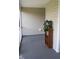 Enclosed porch area showcasing a wooden bookshelf with a potted plant, providing a tranquil outdoor space at 411 Joneshaven Dr, Fuquay Varina, NC 27526