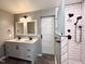Elegant bathroom featuring double vanity, modern lighting and walk-in shower at 419 Jera Dr, Garner, NC 27529
