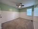 Cozy bedroom with carpet, ceiling fan, and wainscoting at 419 Jera Dr, Garner, NC 27529