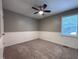 Neutral bedroom with modern ceiling fan, carpet, and natural light from window at 419 Jera Dr, Garner, NC 27529