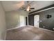 Spacious bedroom with a ceiling fan, sliding barn door, and neutral carpeting at 419 Jera Dr, Garner, NC 27529