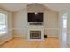Bright living room with hardwood floors, a fireplace with a modern mantel and neutral wall colors at 419 Jera Dr, Garner, NC 27529
