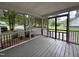 Inviting screened porch with black railing and wood plank flooring for relaxing outdoors at 419 Jera Dr, Garner, NC 27529