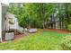 Lush backyard with a patio, treehouse, and green lawn at 4329 Hawksong Pl, Cary, NC 27518