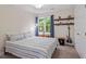 Bedroom with a large window, carpet, and shelves with guitar at 4329 Hawksong Pl, Cary, NC 27518