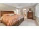 Spacious bedroom with wood bed frame, carpet floors, ensuite bath, and sunny window at 4329 Hawksong Pl, Cary, NC 27518