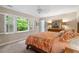 Bright bedroom featuring a large window, wood furniture, and an ensuite bath at 4329 Hawksong Pl, Cary, NC 27518