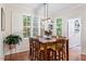 Bright dining area with a wooden table, seating for six, and white plantation shutters at 4329 Hawksong Pl, Cary, NC 27518
