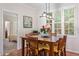 Dining area featuring a wooden table with seating for six and bright windows with plantation shutters at 4329 Hawksong Pl, Cary, NC 27518