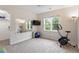 Bright exercise room with carpet, large mirror, television, exercise bike, and natural light from the large window at 4329 Hawksong Pl, Cary, NC 27518