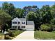 Inviting two story home featuring lush landscaping, green lawn, and paved driveway at 4329 Hawksong Pl, Cary, NC 27518