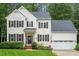Charming two-story home with manicured lawn, black shutters, and a cozy front porch at 4329 Hawksong Pl, Cary, NC 27518