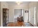 Hallway featuring hardwood floors and a view into a sitting room leading to the home's front door at 4329 Hawksong Pl, Cary, NC 27518