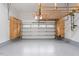 Spacious garage featuring epoxy flooring, ample storage, and a white garage door at 4329 Hawksong Pl, Cary, NC 27518