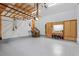 Spacious garage featuring an epoxy floor, wooden cabinets with workspace, and wooden ceiling rack for additional storage at 4329 Hawksong Pl, Cary, NC 27518