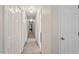 Hallway with carpet and many white paneled doors leading to bedrooms and closets at 4329 Hawksong Pl, Cary, NC 27518