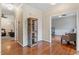 Hallway showcasing hardwood floors, elegant trim, and a decorative cabinet between an entry to other rooms at 4329 Hawksong Pl, Cary, NC 27518