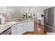 Kitchen featuring stone countertops, white cabinets, modern appliances, and stainless steel sink at 4329 Hawksong Pl, Cary, NC 27518