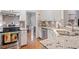 Kitchen showcasing granite countertops, stainless steel appliances, ample storage, and tile backsplash at 4329 Hawksong Pl, Cary, NC 27518