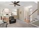 Open living room with a fireplace, neutral carpet, and views to the kitchen and entryway at 4329 Hawksong Pl, Cary, NC 27518