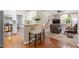 Living room with hardwood floors, island with barstool seating and stairs to the second floor at 4329 Hawksong Pl, Cary, NC 27518