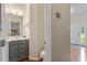 A half-bath with a vessel sink and granite counters, plus a view to the front door at 4329 Hawksong Pl, Cary, NC 27518