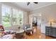 Sitting room with hardwood floors, large windows, comfortable seating, and a view of the yard at 4329 Hawksong Pl, Cary, NC 27518