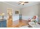 Cozy sitting room with hardwood floors, neutral walls, chair with floral accents and stylish furnishings at 4329 Hawksong Pl, Cary, NC 27518