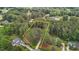 Aerial view showcasing the property's outline, surrounded by lush greenery and mature trees for privacy at 4416 Thistlehill Ct, Raleigh, NC 27616