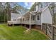 Back of house featuring a porch, a deck, and green grass at 4416 Thistlehill Ct, Raleigh, NC 27616