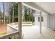 Covered portion of the back deck with hanging plants and a built-in bench, creating a cozy and inviting atmosphere at 4416 Thistlehill Ct, Raleigh, NC 27616