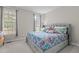 Bright bedroom featuring plush bedding and large windows, perfect for relaxation and comfort at 4416 Thistlehill Ct, Raleigh, NC 27616
