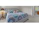 Cozy bedroom featuring a gray tufted headboard, a patterned quilt, and soft, inviting pillows at 4416 Thistlehill Ct, Raleigh, NC 27616