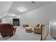 Spacious bonus room with high ceilings, plush carpeting, comfortable seating, and a TV entertainment center at 4416 Thistlehill Ct, Raleigh, NC 27616