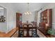 Formal dining room with dark wood furniture, decorative china cabinets, and ample seating for gatherings at 4416 Thistlehill Ct, Raleigh, NC 27616