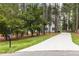 Long driveway leading to a beautiful home surrounded by tall trees at 4416 Thistlehill Ct, Raleigh, NC 27616
