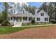 Charming two-story home featuring a welcoming front porch with a bright green door and well-manicured landscaping at 4416 Thistlehill Ct, Raleigh, NC 27616