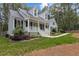 Inviting home with a classic design, featuring a covered front porch, black shutters, and a beautifully landscaped yard at 4416 Thistlehill Ct, Raleigh, NC 27616