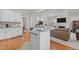 Open kitchen with granite counters and views to living room fireplace and backyard at 4416 Thistlehill Ct, Raleigh, NC 27616