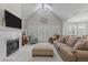 Inviting living room featuring a fireplace, large windows, and comfortable seating at 4416 Thistlehill Ct, Raleigh, NC 27616