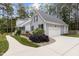 Well-maintained home with an attached two-car garage, complemented by lush landscaping and a paved driveway at 4416 Thistlehill Ct, Raleigh, NC 27616