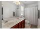 Bathroom featuring double vanity, large mirror, updated lighting, and shower tub combo with curtain at 4605 All Points View Way, Raleigh, NC 27614