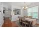 Bright dining room features hardwood floors, large window, and modern chandelier at 4605 All Points View Way, Raleigh, NC 27614