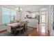 Dining room adjacent to kitchen featuring hardwood floors and natural light at 4605 All Points View Way, Raleigh, NC 27614